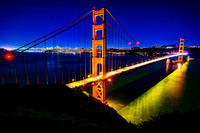 Golden Gate Bridge and San Francisco glowind at night.